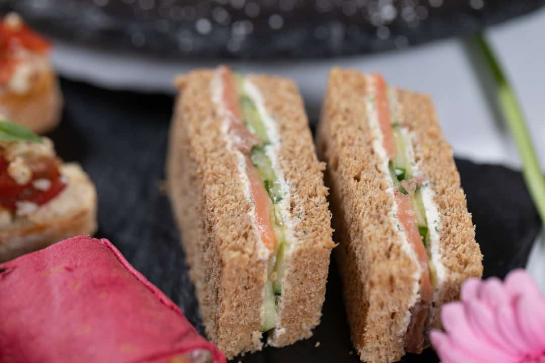 Smoked Salmon, cucumber, with dill, & lemon cream finger sandwich close up